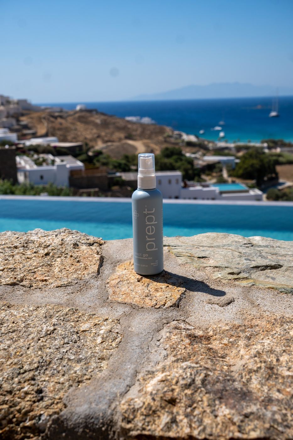 A product bottle on sunlit rocks above the sea
